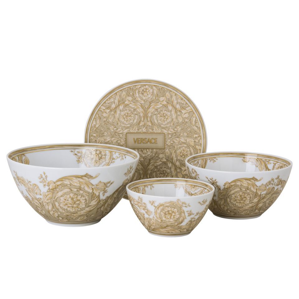 Versace porcelain bowl set with intricate golden baroque floral designs, including three bowls and a matching round tray, all featuring the Versace logo.