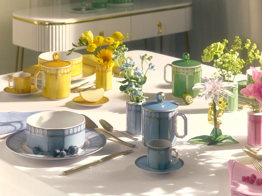 Tasses &agrave; caf&eacute; et mugs Rosenthal de la collection Swarovski x Rosenthal, aux couleurs vives, dispos&eacute;s de mani&egrave;re d&eacute;corative sur une table dress&eacute;e.