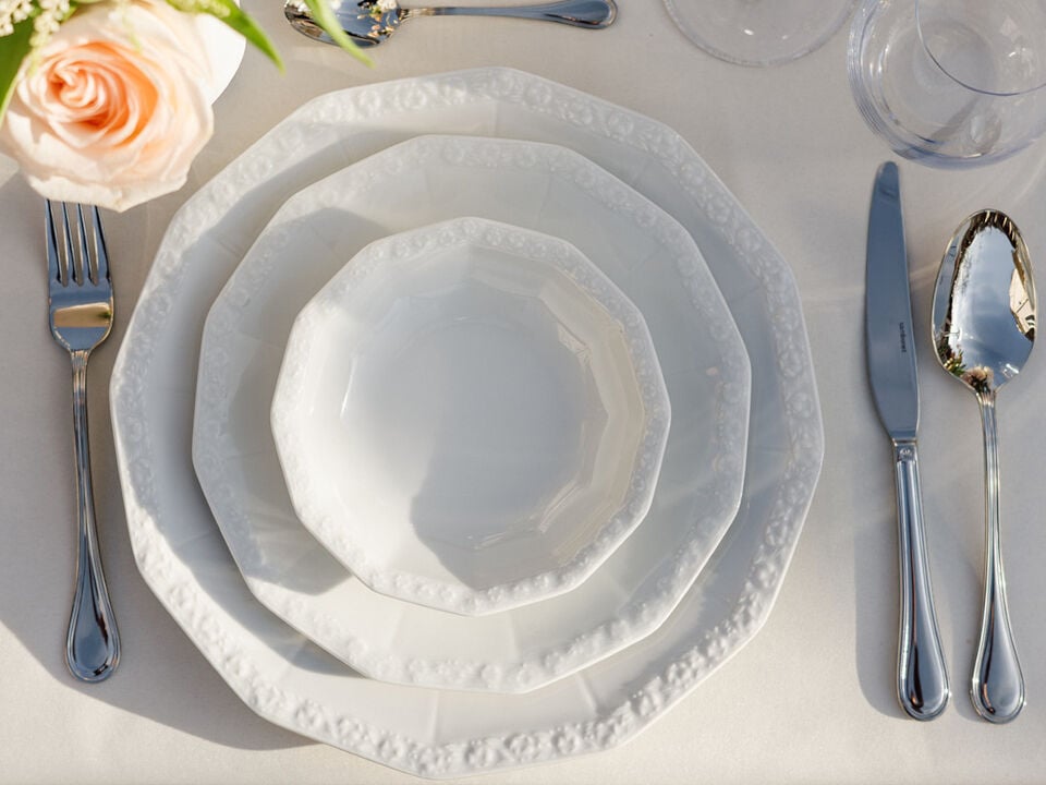 Plate arrangement with two plates and bowl set with cutley and flower