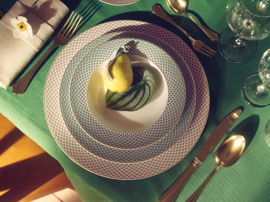 Rosenthal porcelain plates with modern pattern design, table setting with green tablecloth, napkin and gold cutlery