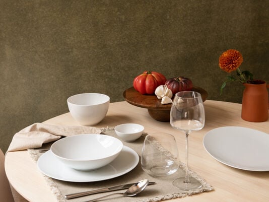 Set wooden table with plates, bowls and glas