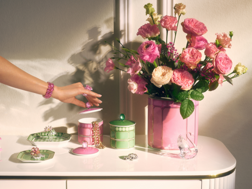 Elegant Rosenthal accessories in fresh colours, arranged on a chest of drawers, combined with a lush bouquet of flowers.
