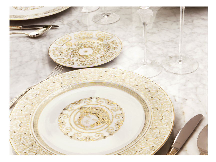 Rosenthal meets Versace Medusa dinnerware with golden details on marble table, luxury table setting