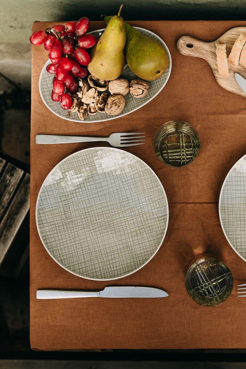View from above of a table set for two with the Mesh Dining Collection, Mesh glasses, cutlery and served with pears, grapes, walnuts and baguette.
