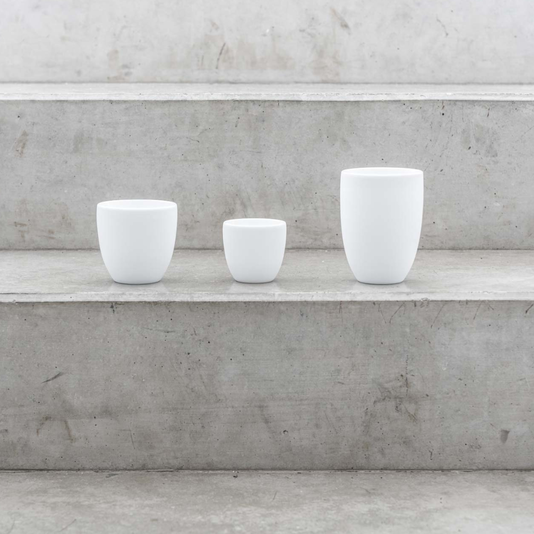 Drei weiße Kaffeetassen auf grauen Marmor Treppen