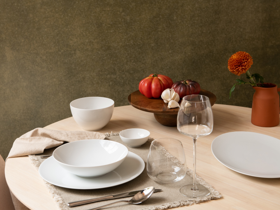 Set wooden table with plates, bowls and glas