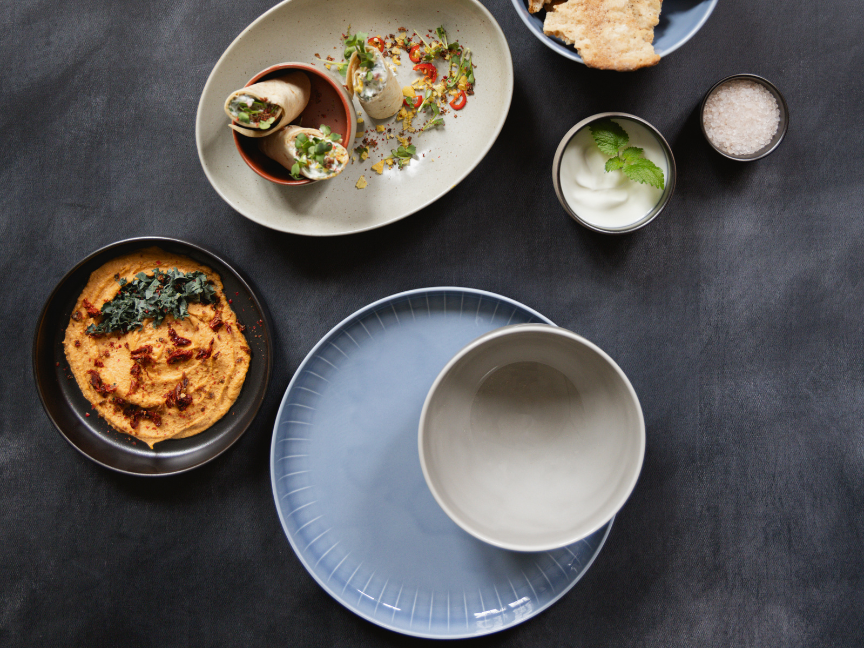 Modern table setting with Mediterranean dishes served on Rosenthal Joyn tableware in muted natural tones and minimalist design