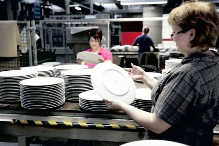 Production workers sorting white Rosenthal plates
